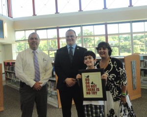 Mr. Pearson posing for photos with Mr. Litz and his family. Litz will replace Pearson as Principal starting the 2014-2015 school year.