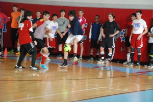 Sophomore Steven Doherty practices his skills with fellow sophomores. Boys soccer tryouts were held in the main gym instead of the field. 
