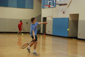 Sophomore Chris Beddow practices during tennis tryouts. According to coach James MacIndoe, more than 28 people are trying out for boys tennis, an increase from previous years’ typical count of about 18 to 20.