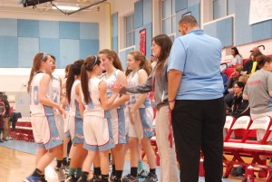 Assistant Coach Lindsey Hardenbergh and freshman Audra Scheinman high-five as the girls freshman basketball team celebrates its win over Mount Vernon on Jan. 29.