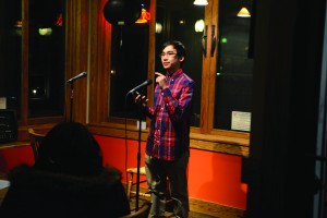 Freshman Matthew Harrington reads his screenplay aloud at an open mic night at Caffe Amouri in Vienna. (Alexandra Lyalikov/Columbian)