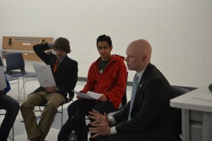 At-large school board member and Marshall alumnus Ryan McElveen sits with members of the Young Democrats club.