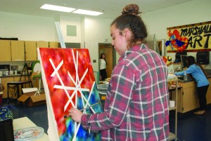“Juxtaposition” is Rosenburg’s most recent work-in-progress. “I was going for the juxtaposition between these clean hard lines that I’d made with the white, compared to the blurred colors in the back. I’m working around that concept,”  Rosenburg said.