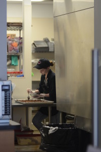 An employee at Cameron’s Coffee makes chocolate caramels, one out of a collection of confections they sell as part of their display case which also includes mint truffles and chocolate pecans. 