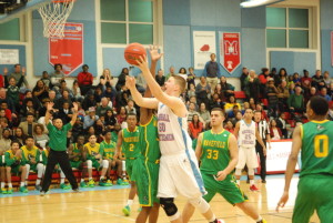 During a game against Wakefield High School on Feb 5, junior Jack Foley takes a shot from under the basket. The Statesmen won the game 52-45 and ultimately finished the regular season with a 18-3 record.