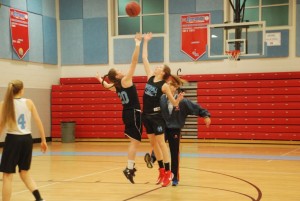 Juniors Lauren Deaver (left) and Leah Walters (right) practice tip-offs during a practice on Feb 11. Although girls varsity struggled throughout the season, ending with a 5-17 record, they still found pride in some of their other accomplishments.