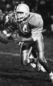 Keith Lyle plays in a game in 1990 as a member of the Marshall Varsity football team. Lyle played  the position of quarterback and defensive back.