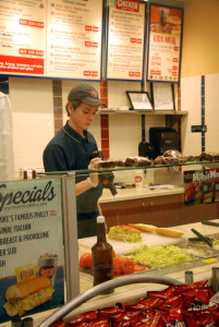 Junior Ian McDonald prepares a sandwich at Jersey Mike's Subs near the Dunn Loring station on March 4. "Having a job not only helps you become a better person overall, like having to be nice while dealing with pesky customers, but it also helps you learn to watch your spending and only buy things you really need," McDonald said.