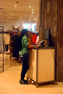 Senior Caroline Mubiru places an order the phone for a customer in the women's section of L.L. Bean at the Tysons location on March 6.