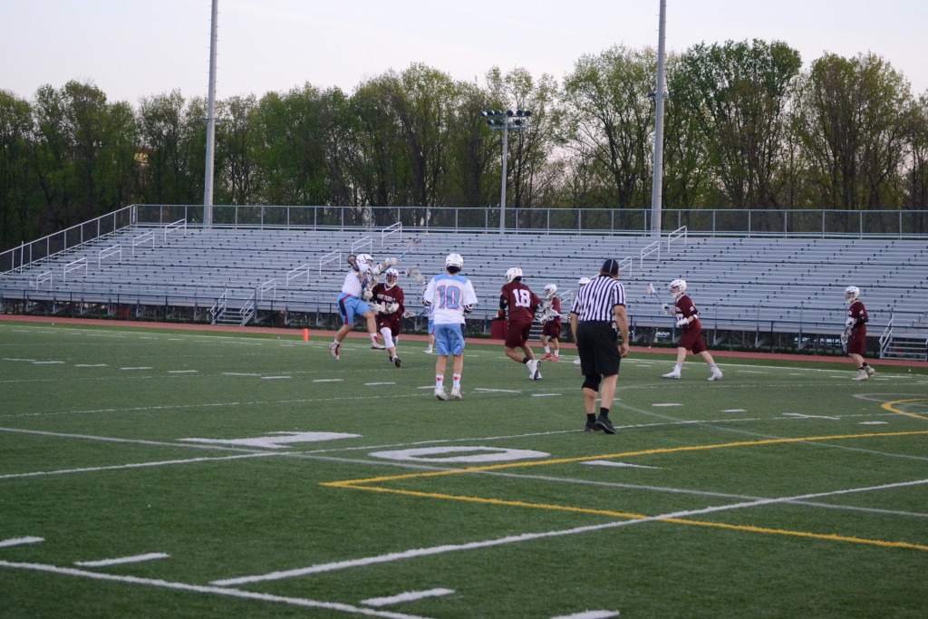 Sophomore Tyler Murphy watches on as senior Josh Hurlburt takes a shot during the April 29 game against Mount Vernon High School.