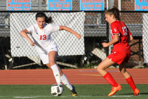 Tonizzo dribbles away from a defender in the junior varsity game against T.C. Williams High School on April 20. The team won 4-3 with Tonizzo scoring the game winning goal.  Photo courtesy of Karen Espaldon
