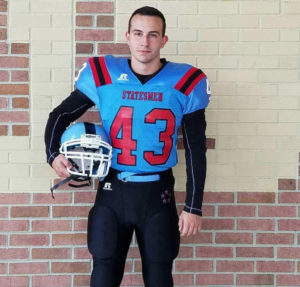 Junior Fabian Tuscher poses in his uniform before the homecoming game on Oct. 21. “I was really excited to be there and to feel the spirit right before the biggest game of our season,” Tuscher said.